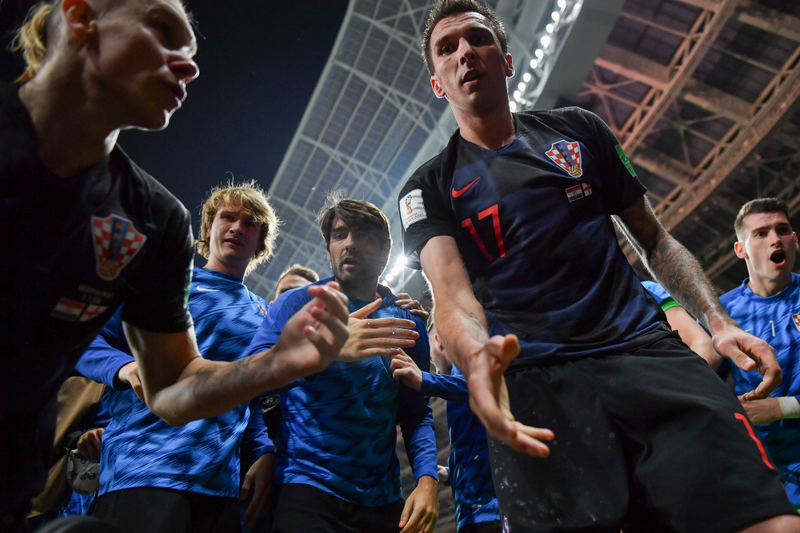 Illustration for article titled Photographer Tackled By Celebrating Croatian Players Got Incredible Photos, Kisses